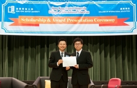 Student receiving an Award from Dr. Sam Lau (left), Director, College of International Education, HKBU.