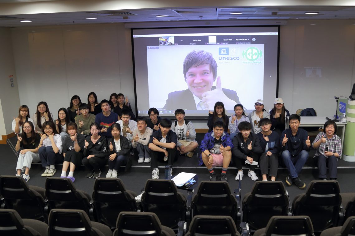 A Group photo of GRMG students and the two distinguished guests Mr. Alvin Ng (second right, first row) and Mr. Theodore Brown (shown on the screen).