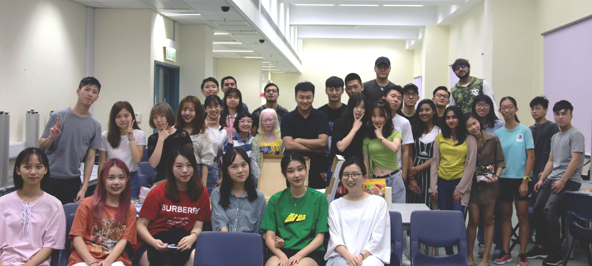 Participants posing for the group photo right before the pizza feast.